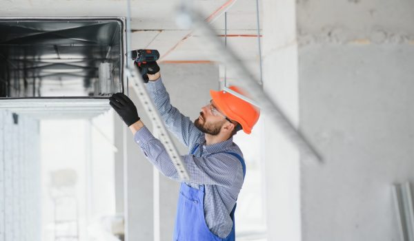 hvac engineer install heat recovery ventilation system for new house. copy space.